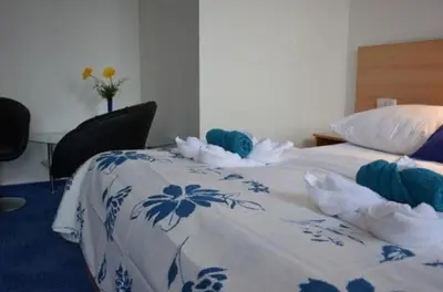 a bed with two stuffed animals on top of it at Hotel O.K. 1 in Beroun