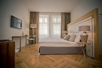 a large bedroom with a large bed and a window at Jungmann Hotel in Prague