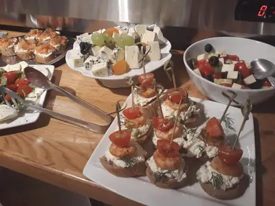 a group of appetizers on a wooden table with plates of food at Jungmann Hotel in Prague