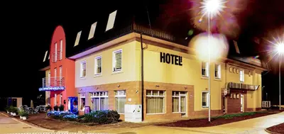 a building with a hotel on the side of it at Hotel NED HOCKEY in Nymburk