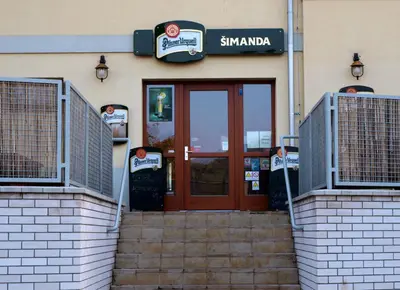 a entrance to a building with a red door at Penzion a Restaurace Simanda in Prague