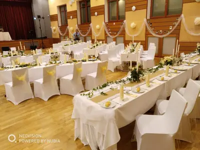 a banquet hall with white tables and white chairs at Penzion a Restaurace Simanda in Prague