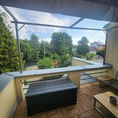a balcony with a bench and a view at Penzion a Restaurace Simanda in Prague