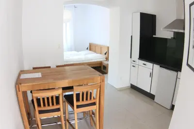 a kitchen with a table with chairs and a television at Family Lorenz & Coffee House in Prague