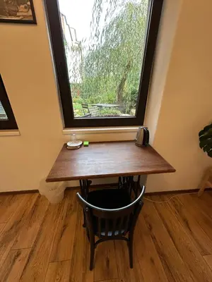 a table in a room with a window at Family Lorenz & Coffee House in Prague
