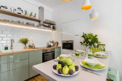 a kitchen with a table with plates of fruit on it at APT with sunny garden Prague by Michal&Friends in Prague