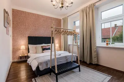 a bedroom with a canopy bed and a window at APT with sunny garden Prague by Michal&Friends in Prague