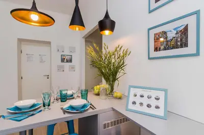 a dining room table with blue plates and glasses at APT with sunny garden Prague by Michal&Friends in Prague