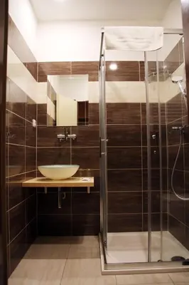 a bathroom with a sink and a shower at Penzion Alfa Poděbrady in Poděbrady