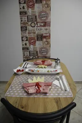 a wooden table with food on it with a plate of food at Penzion Alfa Poděbrady in Poděbrady
