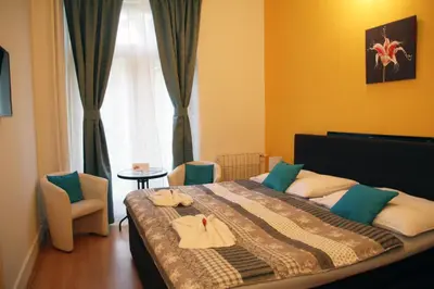 a bedroom with a bed with towels on it at Penzion Alfa Poděbrady in Poděbrady