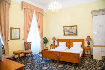 a bedroom with a bed and a chandelier at Chateau Zbiroh in Zbiroh