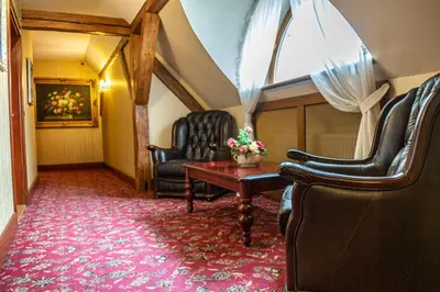 a living room with two chairs and a table at Chateau Zbiroh in Zbiroh