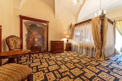 a room with a table and a chair in a room at Chateau Zbiroh in Zbiroh