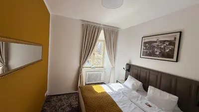 a bedroom with a bed and a window at Hotel Tynec in Týnec nad Sázavou