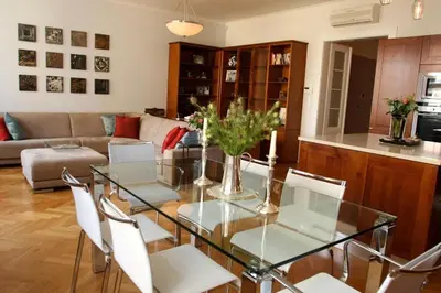 a living room with a glass table and chairs at Spacious elegance in the heart of Old Town in Prague