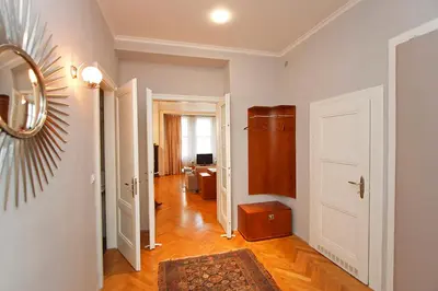 a room with a hallway with a door and a living room at Spacious elegance in the heart of Old Town in Prague