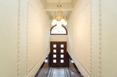 a hallway with a door and a chandelier at Spacious elegance in the heart of Old Town in Prague