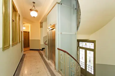 a hallway with a staircase with a blue wall at Spacious elegance in the heart of Old Town in Prague