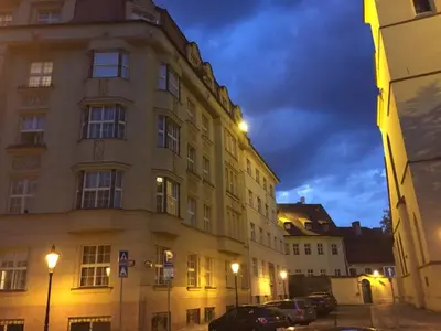 a building in a city with cars parked in front of it at Spacious elegance in the heart of Old Town in Prague