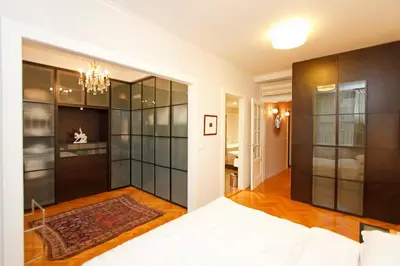 a bedroom with a bed and a chandelier at Spacious elegance in the heart of Old Town in Prague