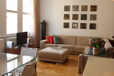 a living room with a couch and a table at Spacious elegance in the heart of Old Town in Prague