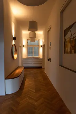 a hallway with a bench and a window at Bright stylish central apartments Prague in Prague