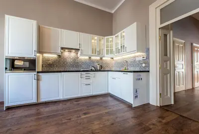 a kitchen with white cabinets and a wooden floor at ✰DOWNTOWN GRAND APARTMENT - Old Town TOP Location✰ in Prague