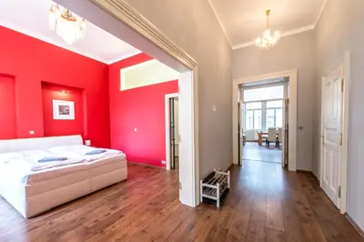 a bedroom with red walls and a white bed at ✰DOWNTOWN GRAND APARTMENT - Old Town TOP Location✰ in Prague