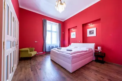 a bedroom with red walls and a white bed at ✰DOWNTOWN GRAND APARTMENT - Old Town TOP Location✰ in Prague