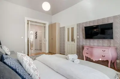 a bedroom with a white bed and a pink dresser at City centre Apartment Prague by Michal&Friends in Prague