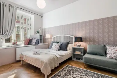 a bedroom with a bed and a couch and a window at City centre Apartment Prague by Michal&Friends in Prague