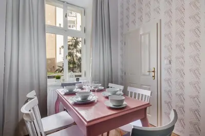 a dining room with a table and chairs and a window at City centre Apartment Prague by Michal&Friends in Prague