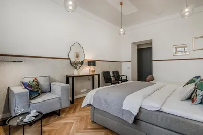a bedroom with a bed and a chair and a table at Prague Trendy Central Apartment by Michal&Friends in Prague