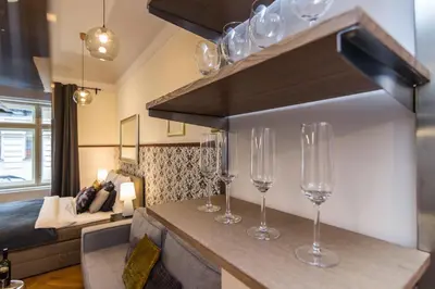 a row of wine glasses on a counter in a room at Prague Trendy Central Apartment by Michal&Friends in Prague