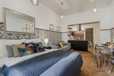 a bedroom with a large bed and a dining room at Prague Trendy Central Apartment by Michal&Friends in Prague