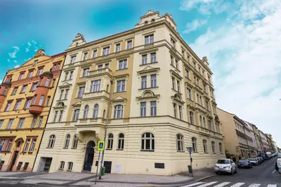 a large yellow building on the side of a street at Prague Trendy Central Apartment by Michal&Friends in Prague