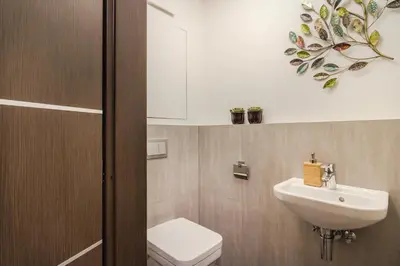 a bathroom with a toilet and a sink and a mirror at Prague Luxury Apartments Parking by Michal&Friends in Prague
