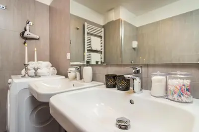 a bathroom with a sink and a mirror at Prague Luxury Apartments Parking by Michal&Friends in Prague