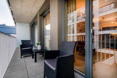 a balcony with chairs and a table on a building at Prague Luxury Apartments Parking by Michal&Friends in Prague