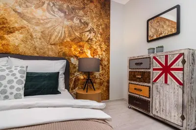 a bedroom with a bed and a painting on the wall at Prague Luxury Apartments Parking by Michal&Friends in Prague