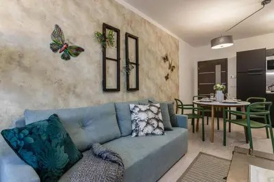 a living room with a blue couch and a table at Prague Luxury Apartments Parking by Michal&Friends in Prague
