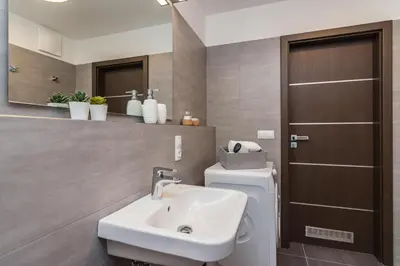 a bathroom with a sink and a toilet and a mirror at Prague Luxury Apartments Parking by Michal&Friends in Prague