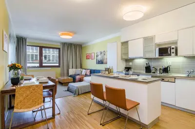 a kitchen and living room with a table and chairs at Luxury Center APT Garage Parking by Michal&Friends in Prague