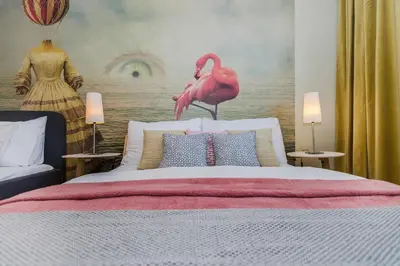 a bedroom with a large bed with a pink flamingo mural at Luxury Center APT Garage Parking by Michal&Friends in Prague
