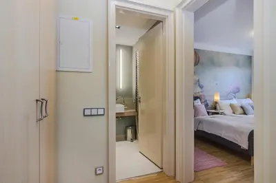 a hallway leading to a bedroom with a bed at Luxury Center APT Garage Parking by Michal&Friends in Prague