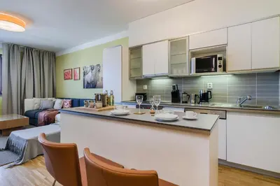 a kitchen with a bar and a living room at Luxury Center APT Garage Parking by Michal&Friends in Prague