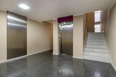 a hallway with a staircase and a elevator at Luxury Center APT Garage Parking by Michal&Friends in Prague