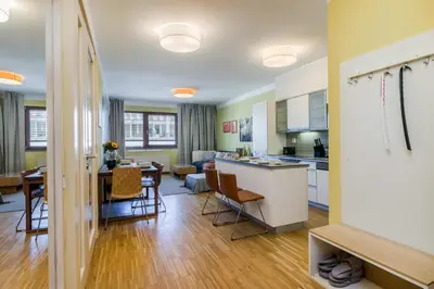 a kitchen and living room with a table and chairs at Luxury Center APT Garage Parking by Michal&Friends in Prague