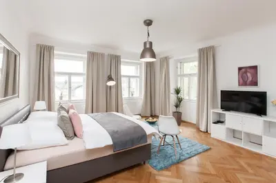 a bedroom with a bed and a window at Prague Historic Center Apartments in Prague